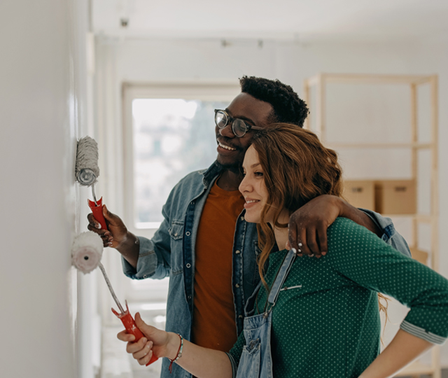 Couple painting a wall