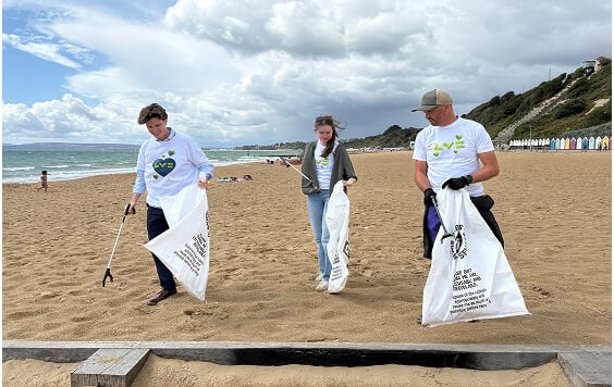 Three LV= colleagues cleaning the beach