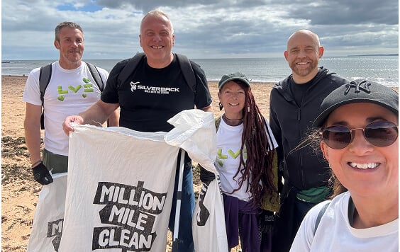 Group of LV= colleagues on the beach with litter pickers and bags