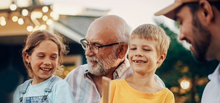 grandad laughing with grandchildren
