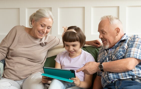 Grandparents playing with granddaughter