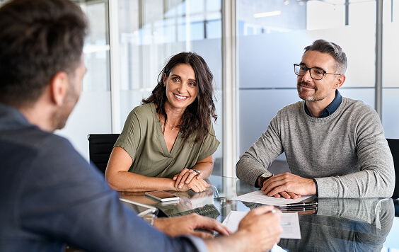 Couple chatting with adviser at a table