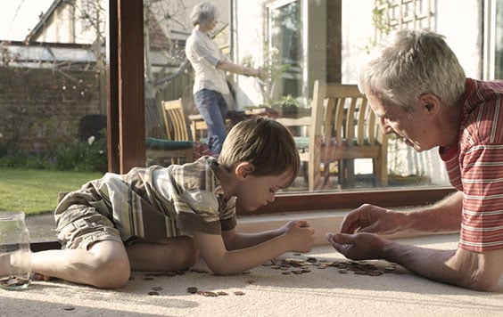Grandad counting money with Grandson