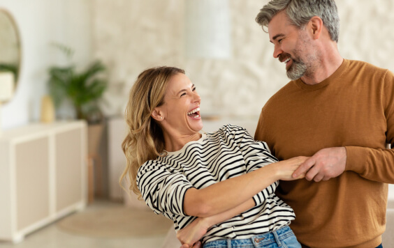Couple smiling at each other in their house
