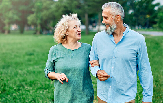 Couple walking outside on grass