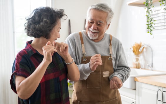 Two people dancing in the kitchen