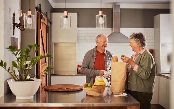 Older couple unpacking their groceries