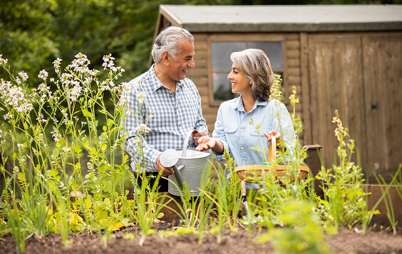 Older couple watering some plants