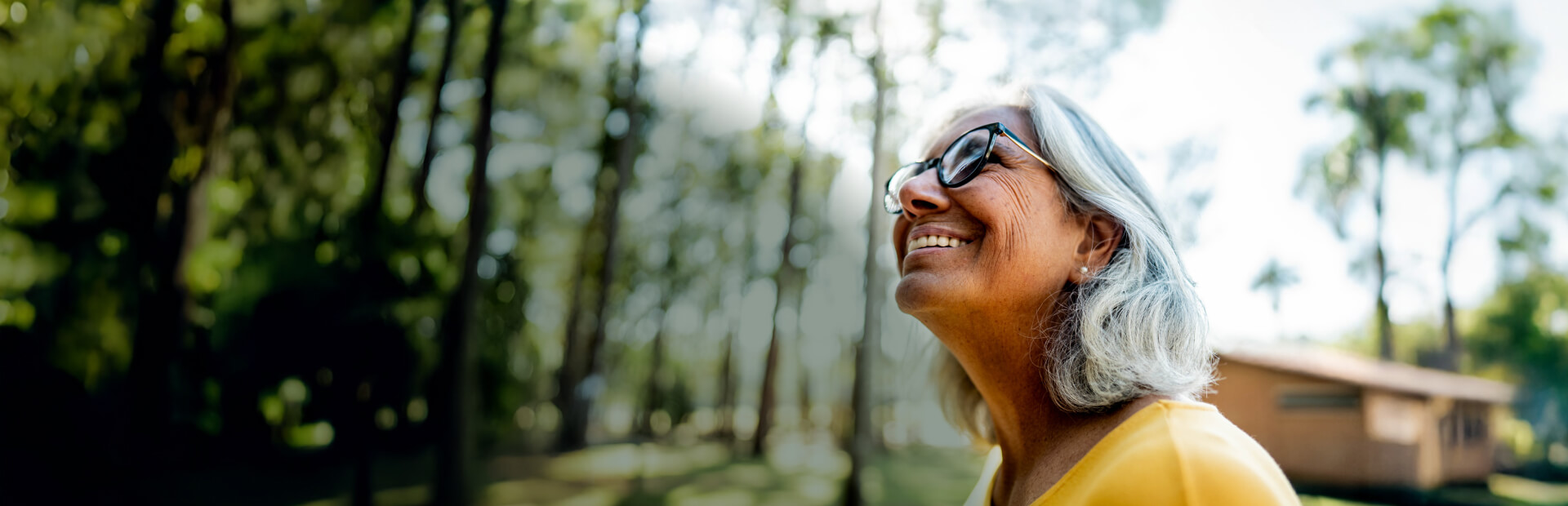 Happy woman of retirement age smiling in the woods