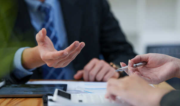 Two pairs of hands seemingly doing a deal of some sort