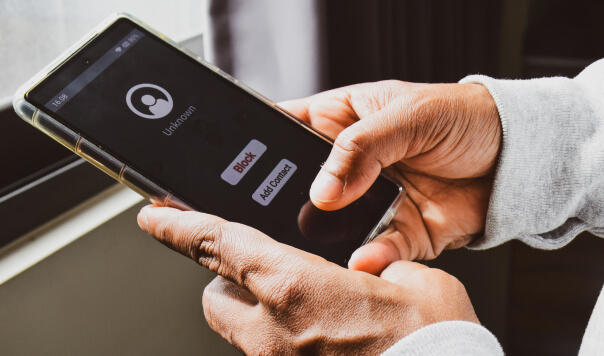 Hands holding a phone receiving a call from an unknown number