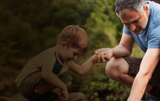 Dad playing with child in river