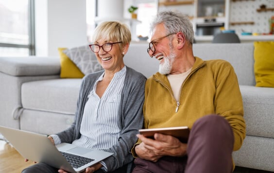 Happy romantic senior couple hugging and enjoying retirement at home