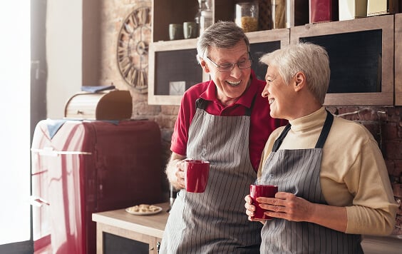 Older couple drinking form their mugs