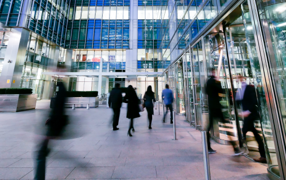 People walking with tall buildings in background