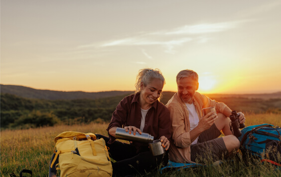 happy-couple-relaxing-after-a-trek-564x356