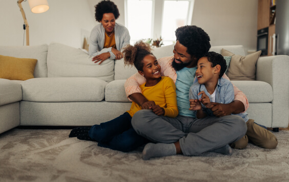 Family cuddling in their lounge