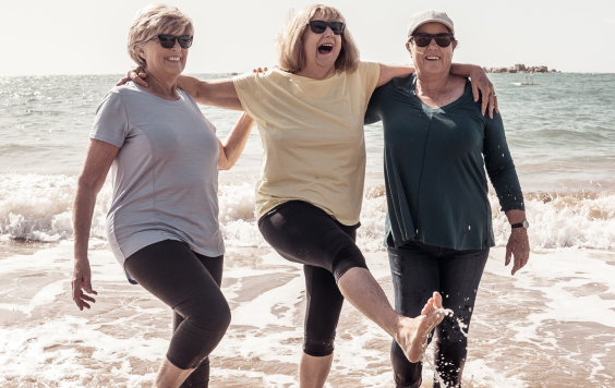 Three older people on the beach