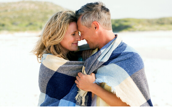Couple gazing into each others eyes on the beach