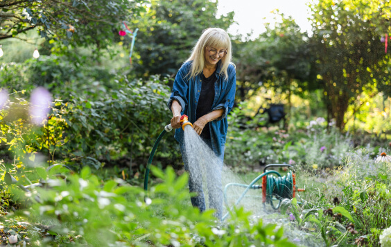 Woman watering her plants in a garden
