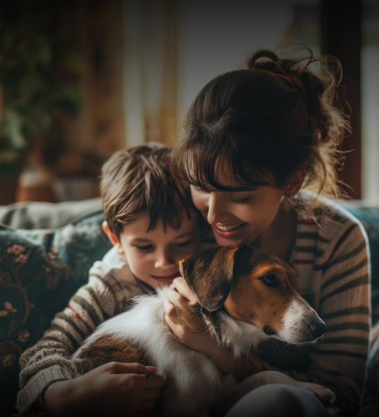 Happy mother and son at home petting their dog 