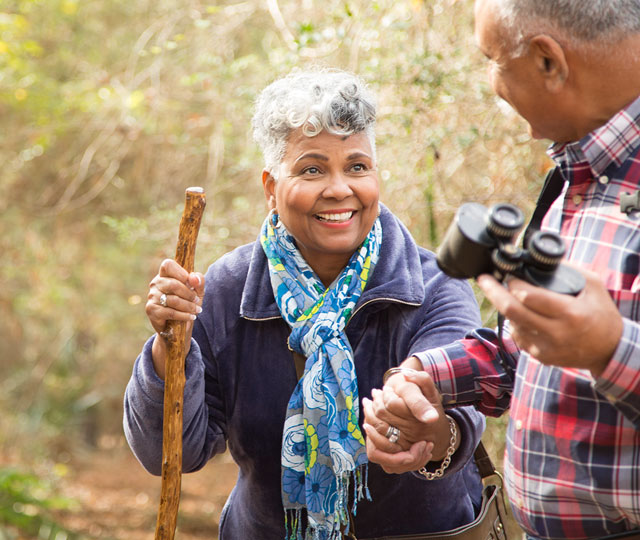 Older couple hiking in the wild. 