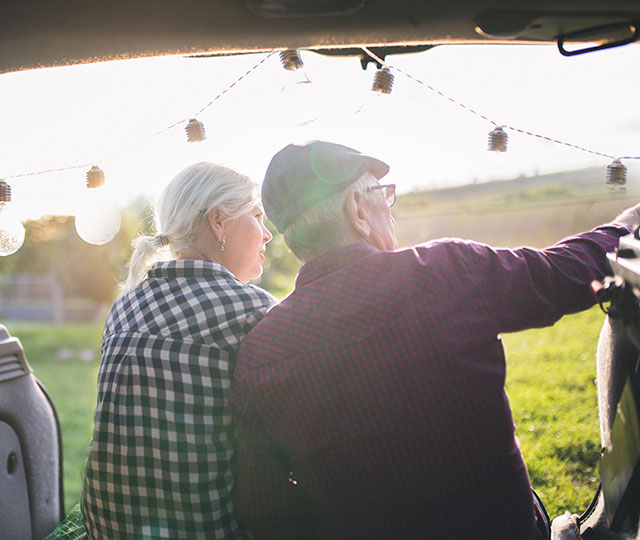 Couple sitting and looking into a field