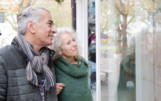 Senior couple window shopping at storefront