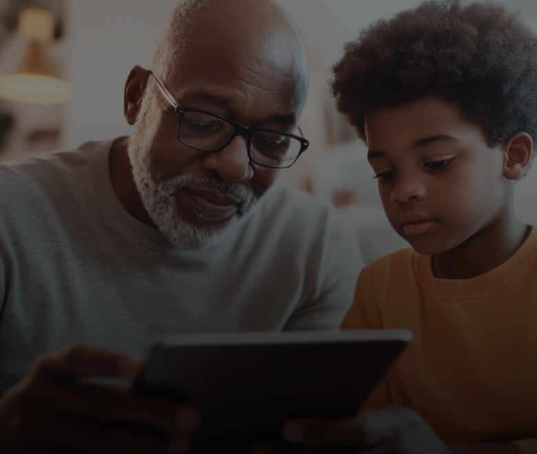 Grandfather reading to his attentive grandson 