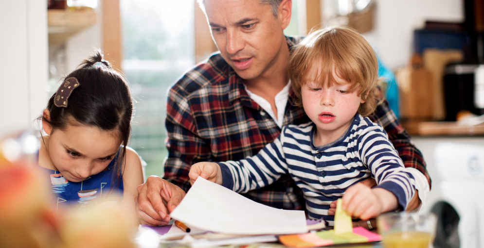 Dad doing homework with children