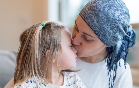 Mother kissing her daughter