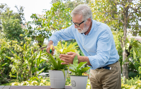 Older man watering his plant