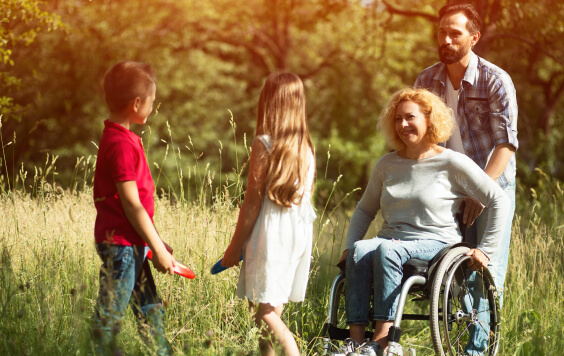 Family playing with a woman in a wheelchair