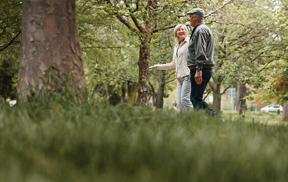 Older couple walking in a forest