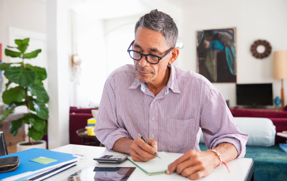 Man writing at a desk