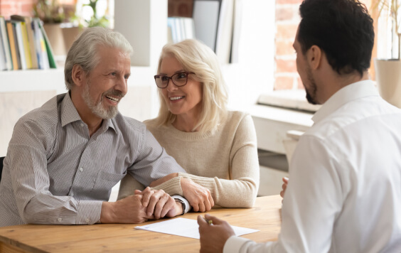 Older couple talking with a professional man