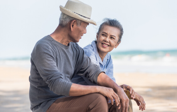 Older couple sitting on the beach
