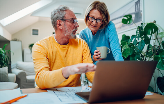 Couple looking at their laptop
