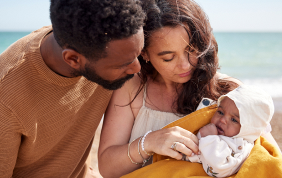 Couple with baby on a beach