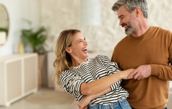 Couple smiling at each other in their house