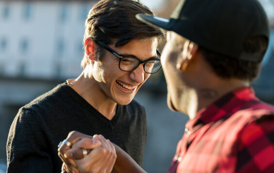 good friends joking about their secret handshake