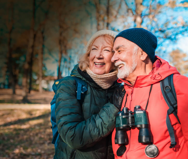 Older couple smiling together on a cold day