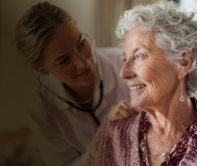 Health visitor and a senior woman during home visit 
