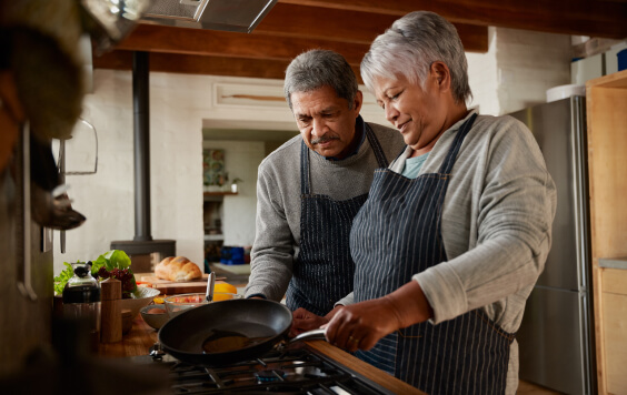 Couple of retirement age cooking together in the kitchen