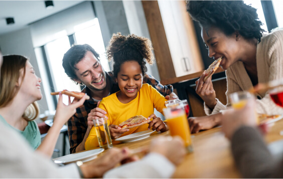 Family smiling around the dinner table