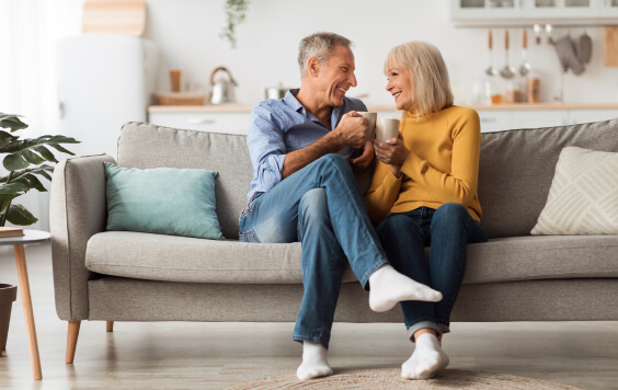 Couple smiling on their sofa