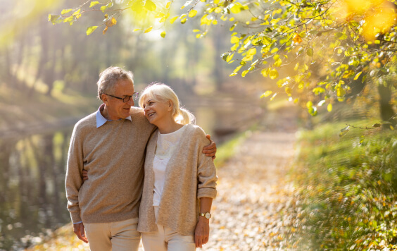 Older couple walking through a forest