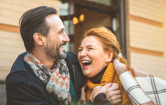 Couple laughing outside together