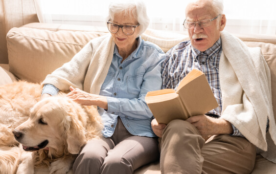 Older couple sat with their dog