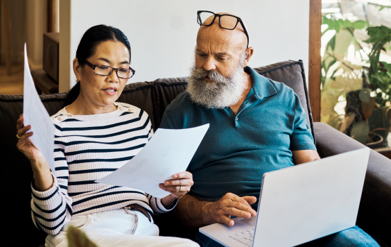 A man and woman looking over some paperwork together